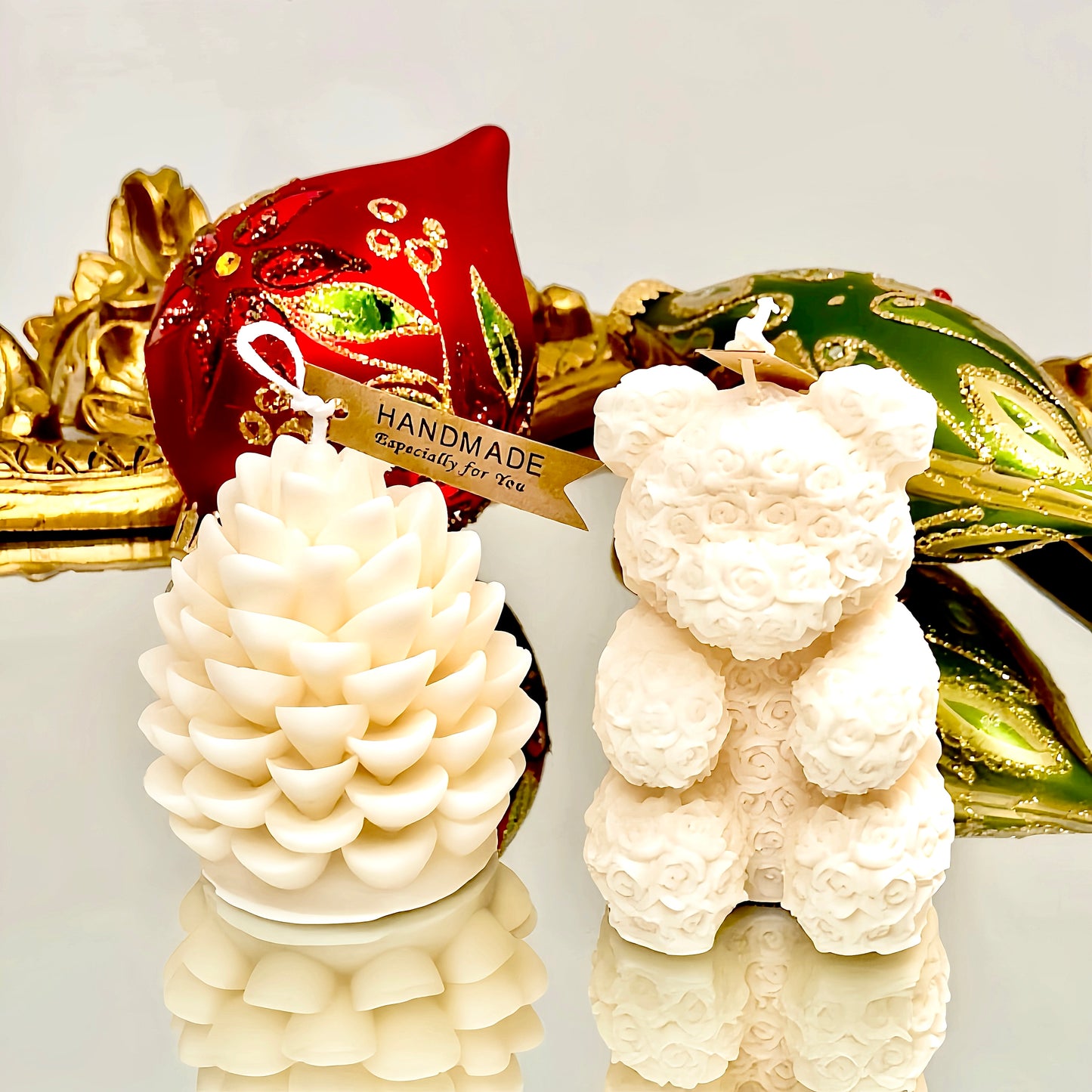 Sculpted white polar bear and pinecone candles in Elite 300 wax, scented at a 10% fine-fragrance load and boxed with a clear-lid gift box for easy holiday giving.