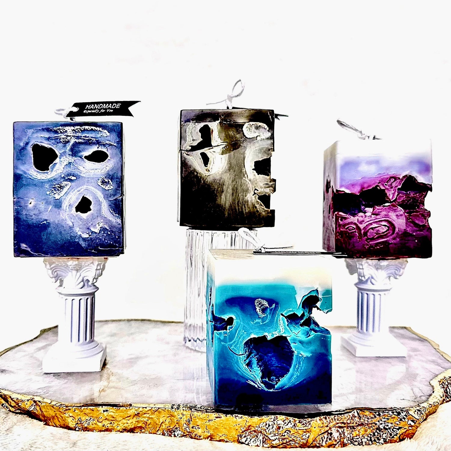 Four square hollow art candles—Deep Blue, Lunar Ash, Olive Strata, Rose Clay—from the Aether Hollows Collection by Zenaura Studio.